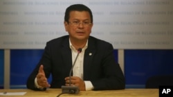 FILE - El Salvadoran Foreign Minister Hugo Martinez, shown at a June news conference in San Salvador, is part of a delegation lobbying U.S. lawmakers to extend two programs shielding its nationals from deportation.