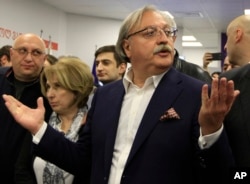 Grigol Vashadze, Georgia's former foreign minister and presidential candidate, center, gestures while speaking to journalists at his headquarters during the presidential election in Tbilisi, Georgia, Oct. 28, 2018.