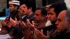 Relatives and family members of Naeem Rashid who was killed along with his son Talha Naeem in the Christchurch mosque attack in New Zealand, pray during a condolence gathering at the family's home in Abbottabad, Pakistan, March 17, 2019.