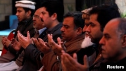 Relatives and family members of Naeem Rashid who was killed along with his son Talha Naeem in the Christchurch mosque attack in New Zealand, pray during a condolence gathering at the family's home in Abbottabad, Pakistan, March 17, 2019.
