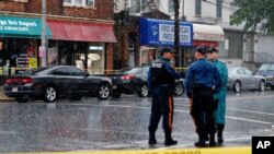 Police officers stand guard while law enforcement officers search an address during an investigation into Ahmad Khan Rahami, who was wanted for questioning in an explosion in New York, which authorities believe is linked to the explosive devices found in