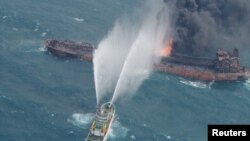 A rescue ship works to extinguish the fire on the Iranian oil tanker Sanchi in the East China Sea, Jan. 10, 2018.