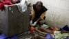 A forensic official tags the bodies of illegal migrants from Burma at a hospital in Medan in Indonesia's North Sumatra province, April 5, 2013.