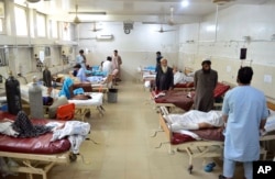 Injured men receive treatment at a hospital following a suicide attack in the city of Jalalabad, east of Kabul, June 11, 2018.