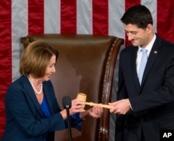 Newly elected House Speaker Paul Ryan of Wis., receives the Speaker's gavel from House Minority Leader Nancy Pelosi of Calif., in the House Chamber on Capitol Hill in Washington, Oct. 29, 2015.