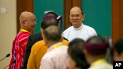Myanmar President Thein Sein, rear right, shakes hands with leaders of armed ethnic groups during a meeting for the Nationwide Cease-fire Agreement (NCA) between representatives of the Myanmar government and leaders of armed ethnic groups in Naypyidaw, Sept. 9, 2015.