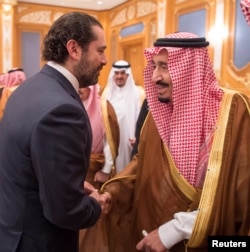 Lebanese Prime Minister Saad Hariri shakes hands with Saudi Arabia's King Salman in Riyadh, Saudi Arabia, Nov. 11, 2017.