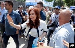Argentina's former President Cristina Fernandez greets supporters outside a courthouse in Buenos Aires, Argentina, Oct. 26, 2017.