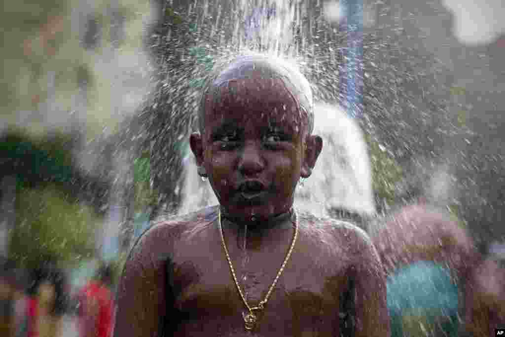 A Hindu devotee gets showered as part of a cleaning ritual before his pilgrimage during the Thaipusam festival in Kuala Lumpur, Malaysia.
