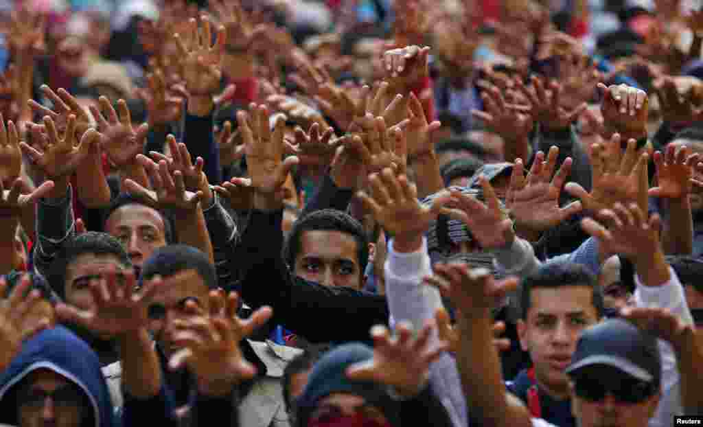 Cairo University students shout slogans against the government after the verdict of former Egyptian President Hosni Mubarak's trial, at the university's campus in Giza, on the outskirts of Cairo. Protests erupted at universities across the country, condemning a court decision to drop criminal charges against Mubarak.