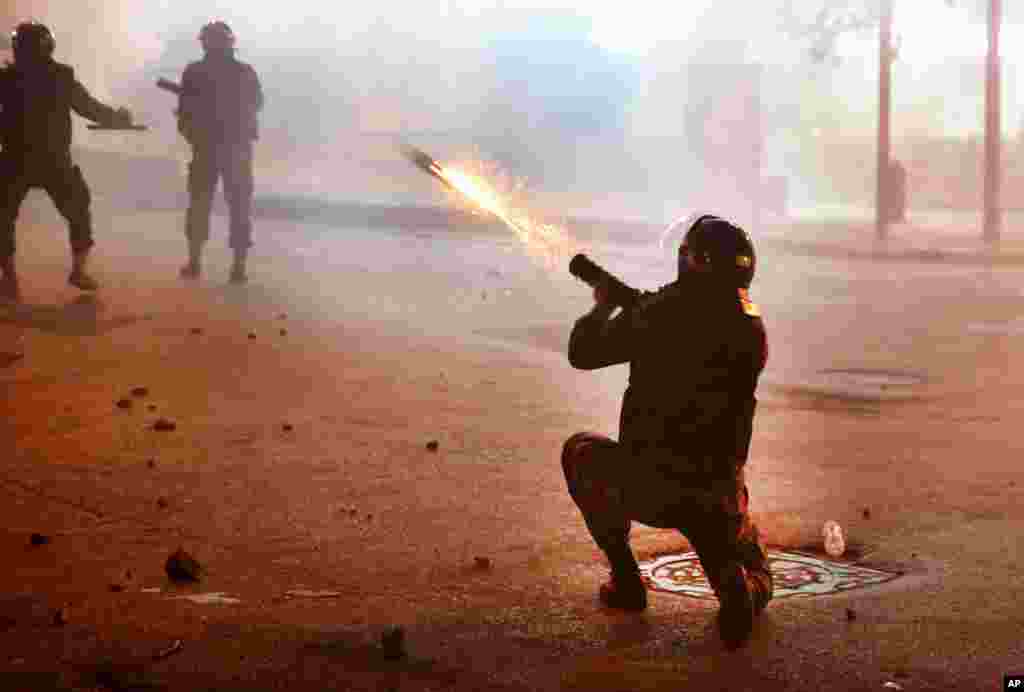 A riot policeman fires tear gas against the anti-government protesters, during ongoing protests against the Lebanese central bank&#39;s governor and the deepening financial crisis, at Hamra trade street, in Beirut, Lebanon, Jan. 14, 2020.
