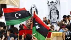 Mourners carry the coffin of a man killed in yesterday's NATO air strike on rebel vehicles on the road between Ajdabiyah and Brega, during Friday prayers in Benghazi, April 8, 2011