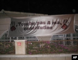 Senegalese demonstrate against President Wade's decision to run for re-election with signs reading “Don’t touch my constitution!” (December 2011)