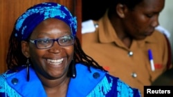 Ugandan prominent academic Stella Nyanzi smiles as she appears at Buganda Road court charged with cybercrimes after she posted profanity-filled denunciations of president Yoweri Museveni on Facebook, in Kampala, Uganda, April 25, 2017. 