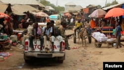 Somali soldiers patrol a street market following a suicide car bomb and gun attack on Tuesday that killed 11 people in Afgoye, Somalia, Oct. 19, 2016. 