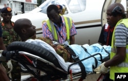 FILE - An injured Kenya Defense Force soldier is stretched into an ambulance to be transfered to the hospital after arriving in Nairobi, Jan. 17, 2016, a day after an attack by the al-Qaeda-linked militants on an African Union base (AMISOM) in southwest Somalia.