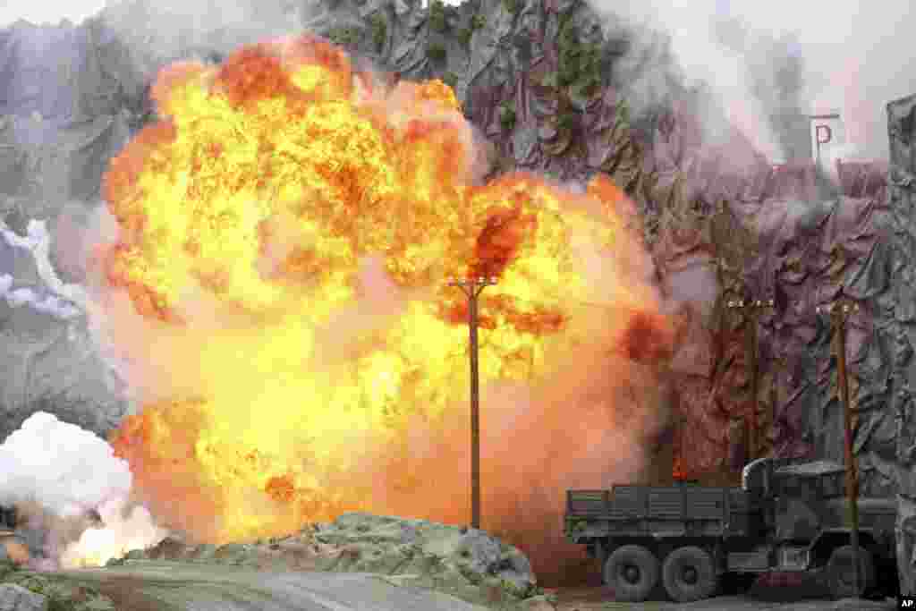 An explosion strikes during a military demonstration targeting a theatrical "ballistic missile launchpad" at the International Defense Exhibition and Conference in Abu Dhabi, United Arab Emirates.