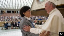 Pope Francis hugs Sister Carmen Sammut, a Missionary Sister of Our Lady of Africa at the end of a special audience with members of the International Union of Superiors General in the Paul VI Hall at the Vatican, May 12, 2016. 