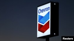 FILE - A Chevron gas station sign is shown in Cardiff, California, Jan. 25, 2016. 