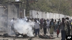 Residents at the scene of a suicide attack in Mogadishu, Oct. 4, 2011.