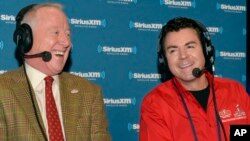 FILE - Papa John's founder John Schnatter, right, and former football star Archie Manning talk on NFL Radio Row during Super Bowl Week on Jan. 30, 2014, in New York.