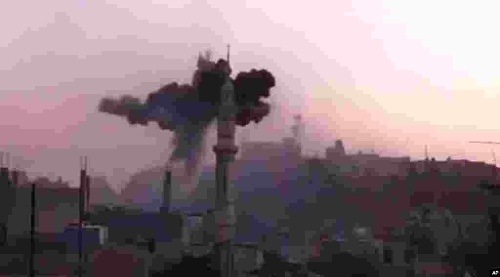 Black smoke from shelling is seen near Ali bin Abi Taleb mosque in Talbiseh, Homs, Syria, July 2, 2012. (AP/Ugarit News) 