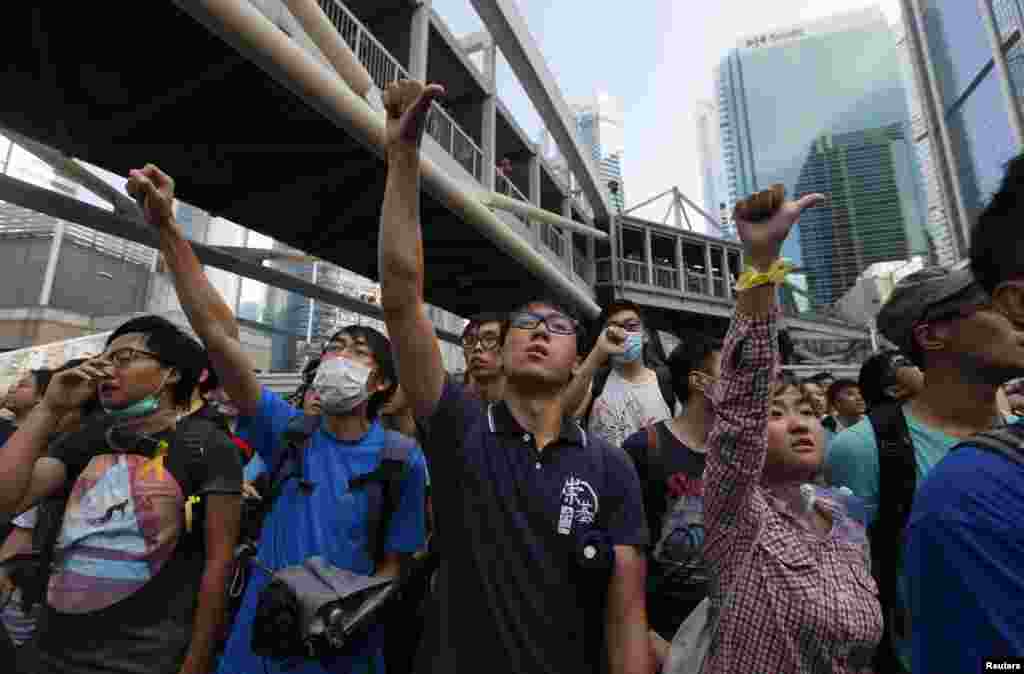 Pro-democracy protesters gesture during a rally at the financial Central district outside the government headquarters in Hong Kong.