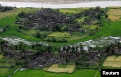 FILE - Aerial view of a burned Rohingya village near Maungdaw, north of Rakhine State, Myanmar, Sept. 27, 2017.