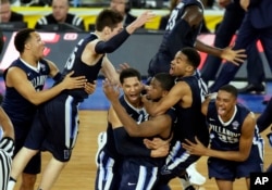 Villanova players celebrates after Kris Jenkins, center, made the game-winning basket as they defeated North Carolina 77-74 in the championship game of the 2016 NCAA Final Four college tournament. (AP Photo/Charlie Neibergall, File)