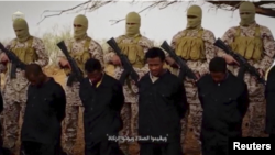FILE - Islamic State militants stand behind what are said to be Ethiopian Christians in Libya, in this still image from an undated video posted to a social media website on April 19, 2015.