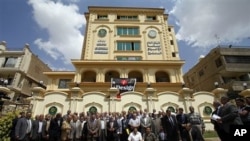 Egyptian Muslim Brotherhood Shura (Consultative) council members gather for a photo op outside the new Muslim Brotherhood headquarters in Cairo, April 30, 2011