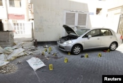 Crime scene markers are seen at a bomb site in capital of Manama, Bahrain, November 5, 2012. Five bombs exploded in the heart of Manama Monday, killing two people, officials said.
