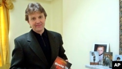 FILE - Alexander Litvinenko, former KGB spy and author of the book "Blowing Up Russia: Terror From Within" photographed at his home in London, May 10, 2002. Andrei Lugovoi is a prime suspect in his poisoning.