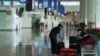 A woman, wearing a face mask following the coronavirus disease (COVID-19) outbreak, sorts luggage at Hong Kong International Airport in Hong Kong, China October 20, 2020. REUTERS/Lam Yik