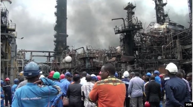 Government officials visit the refinery in Limbe, Cameroon, June 2, 2019, in the aftermath of an explosion that destroyed the facility over the weekend. (M. Kindzeka for VOA)