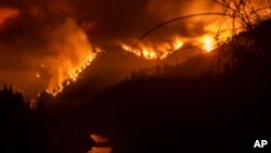 The Delta Fire burns in the Shasta-Trinity National Forest in California, Sept. 5, 2018. Fire officials said the wildfire roaring through timber and brush in Northern California tripled in size overnight, prompting mandatory evacuations.