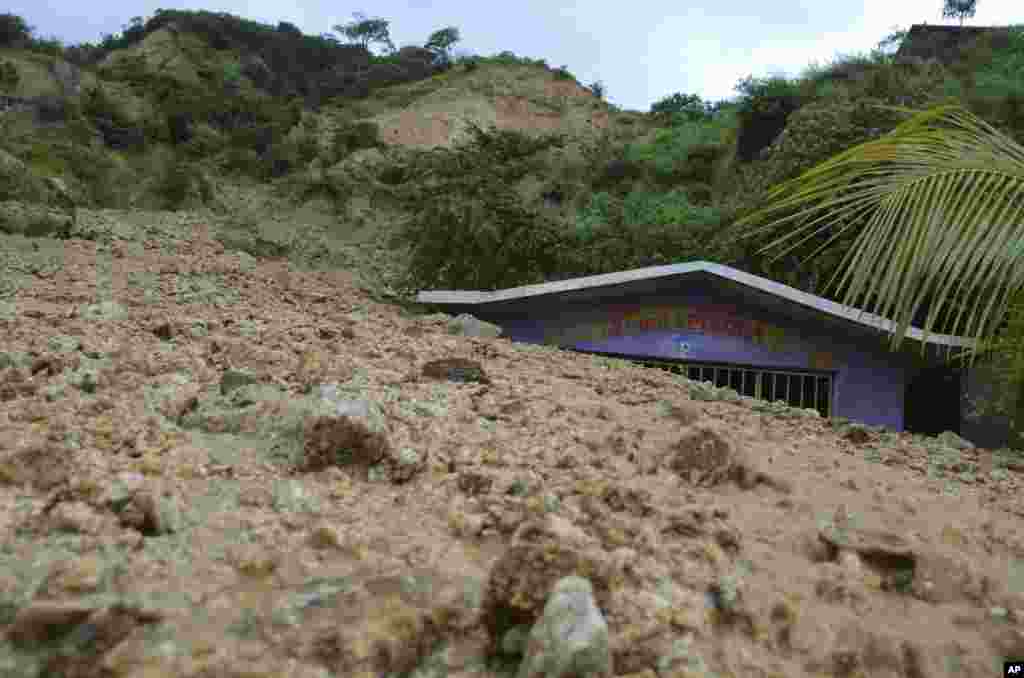 A small chapel is engulfed in rock and mud from a landslide brought on by Tropical Storm Manuel&#39;s heavy rains on the outskirts of Acapulco, Mexico, Sept. 16, 2013. 