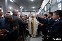 Pope Francis greets inmates and guards as he arrives to celebrate the Holy Thursday at the District House of Velletri prison, in Velletri near Rome, Italy, April 18, 2019.