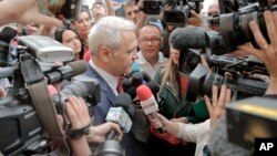 FILE _ The leader of Romania's ruling Social Democratic party, Liviu Dragnea, is surrounded by media as he arrives at the anti-corruption prosecutors' office, in Bucharest, Romania, April 27, 2018. 
