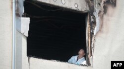 An investigator examines the fire-damaged Hyosarang hospital near Janseong, May 28, 2014.