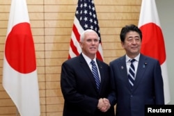 Vice President Mike Pence shakes hands with Japanese Prime Minister Shinzo Abe at Abe’s official residence in Tokyo, Nov. 13, 2018.