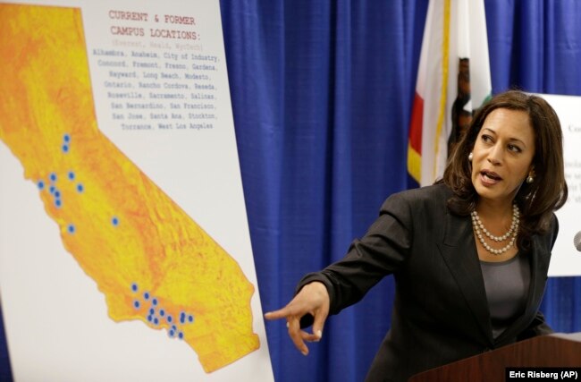 In this March 24, 2016 photo, then-California Attorney General Kamala Harris points to an image showing the location of Corinthian Colleges located in California during a news conference in San Francisco.