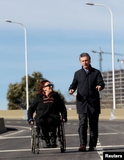 Mauricio Macri (R), Buenos Aires' City Mayor and Argentina's presidential contender walks alongside Senator Gabriela Michetti after he inaugurated a portion of a freeway in Buenos Aires, June 19, 2015.