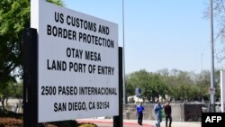 People enter the U.S. at the Otay Mesa port of entry at the U.S.-Mexico border in San Diego, Calif., June 8, 2019. - U.S. President Donald Trump touted on Saturday his deal averting tariffs on Mexico, a plan economists warned would have been disastrous for both nations.