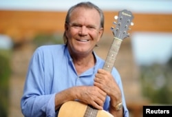 FILE = Recording artist Glen Campbell is photographed at his home in Malibu, California, Aug. 4, 2008.