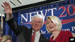Republican presidential candidate and former House Speaker Newt Gingrich waves to the crowd with his wife Callista during a South Carolina Republican presidential primary night rally, Jan. 21, 2012, in Columbia, S.C.