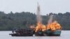 FILE - Malaysian and Vietnamese fishing boats are destroyed for illegal fishing by the Ministry of Maritime Affairs and Fisheries, police and navy, in Batam, Riau Islands, Indonesia, April 5, 2016. The Indonesian government reportedly sank 28 illegal fore