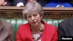 British Prime Minister Theresa May reacts after tellers announced the results of the vote Brexit deal in Parliament in London, Britain, March 12, 2019, in this screen grab taken from video.