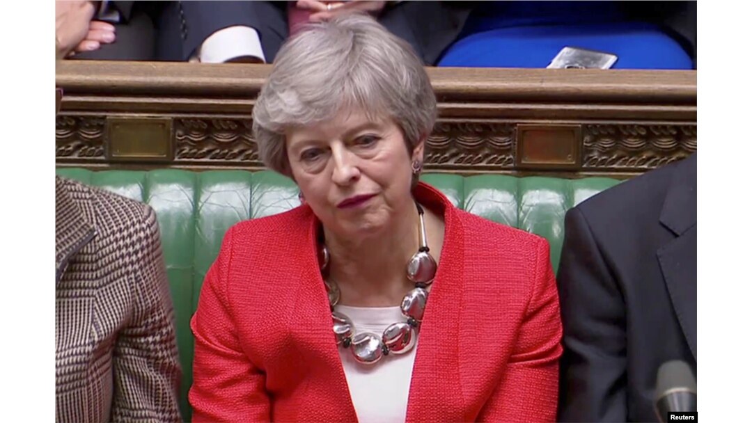 FILE - British Prime Minister Theresa May reacts after tellers announced the results of the vote Brexit deal in Parliament in London, Britain, March 12, 2019, in this screen grab taken from video.