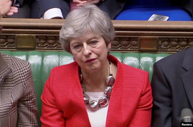 FILE - British Prime Minister Theresa May reacts after tellers announced the results of the vote on her Brexit deal in Parliament, in London, March 12, 2019, in this screen grab taken from video.